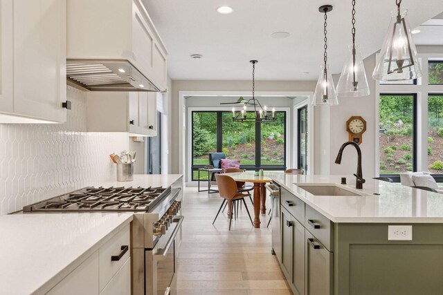 16798 Stirrup Ln, Eden Prairie, MN 55347 - kitchen with appliances with stainless steel finishes, a sink, light countertops, backsplash, and plenty of natural light