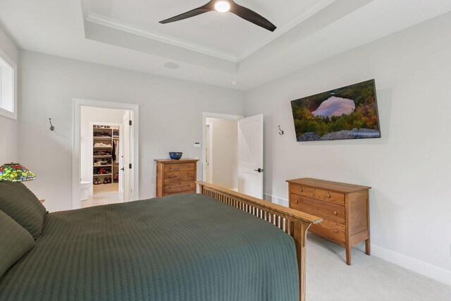 16798 Stirrup Ln, Eden Prairie, MN 55347 - bedroom featuring crown molding, a raised ceiling, a spacious closet, light carpet, and ceiling fan