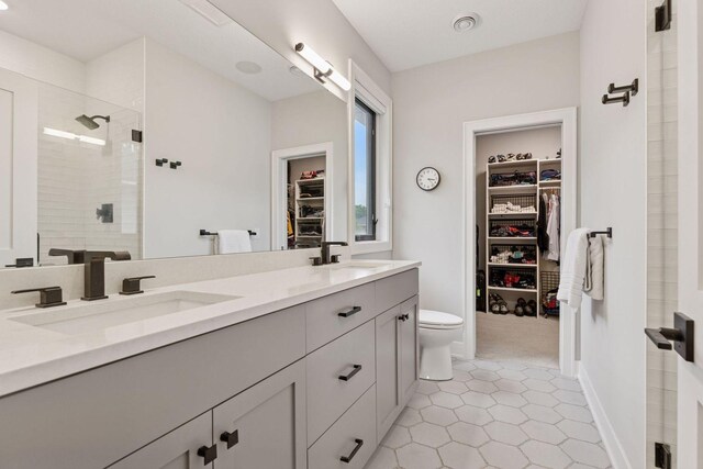 16798 Stirrup Ln, Eden Prairie, MN 55347 - full bath with a stall shower, tile patterned floors, double vanity, a spacious closet, and toilet