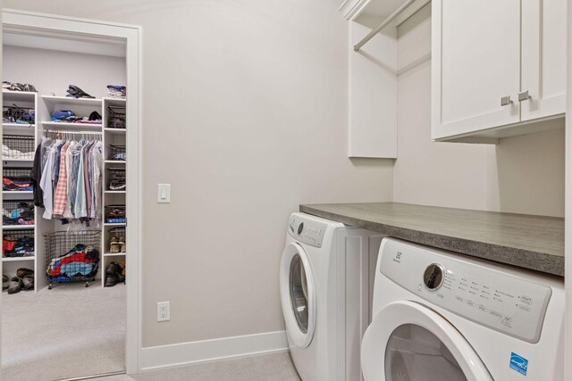 16798 Stirrup Ln, Eden Prairie, MN 55347 - clothes washing area with cabinet space, washing machine and clothes dryer, and baseboards