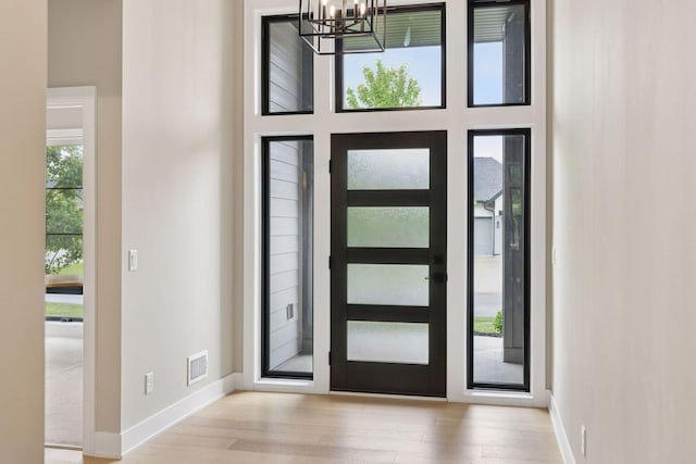 16798 Stirrup Ln, Eden Prairie, MN 55347 - foyer with a chandelier, wood finished floors, and baseboards
