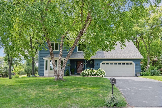 7010 Tartan Curv, Eden Prairie, MN 55346 - view of front facade featuring driveway, a front yard, a garage, and a shingled roof