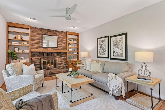 7010 Tartan Curv, Eden Prairie, MN 55346 - living area featuring light wood-type flooring, a ceiling fan, built in shelves, and a fireplace
