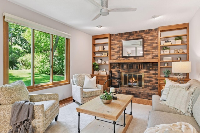 7010 Tartan Curv, Eden Prairie, MN 55346 - living area featuring wood finished floors, a brick fireplace, a ceiling fan, and built in features