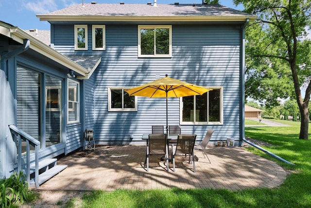 7010 Tartan Curv, Eden Prairie, MN 55346 - back of house featuring a patio area, a lawn, and roof with shingles