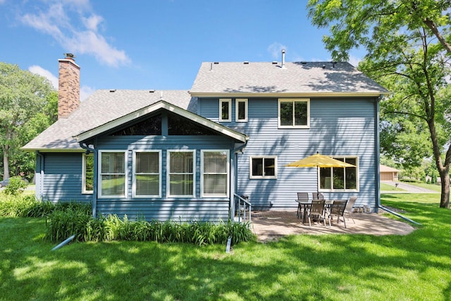 7010 Tartan Curv, Eden Prairie, MN 55346 - rear view of property featuring a lawn, a patio, a chimney, and roof with shingles