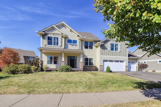1730 Deephaven Dr, Woodbury, MN 55129 - craftsman inspired home with board and batten siding, driveway, stone siding, an attached garage, and a front yard