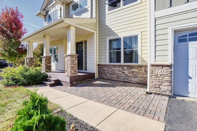 1730 Deephaven Dr, Woodbury, MN 55129 - doorway to property with a porch and stone siding