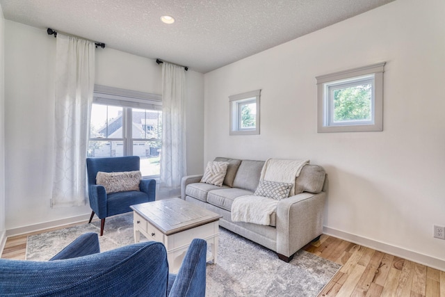 1730 Deephaven Dr, Woodbury, MN 55129 - living area with baseboards, light wood-style floors, a textured ceiling, and recessed lighting
