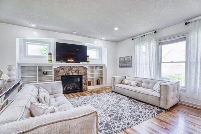 1730 Deephaven Dr, Woodbury, MN 55129 - living room with wood finished floors, a textured ceiling, healthy amount of natural light, baseboards, and recessed lighting