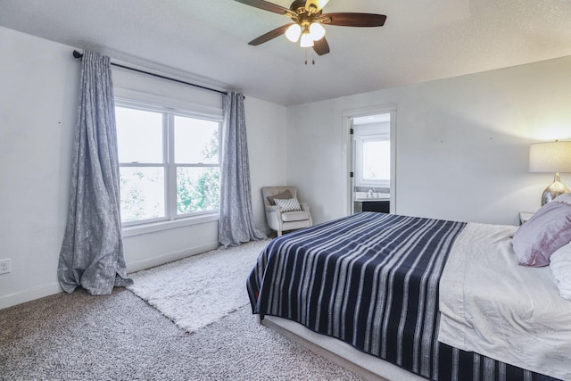 1730 Deephaven Dr, Woodbury, MN 55129 - carpeted bedroom featuring multiple windows, baseboards, connected bathroom, and ceiling fan