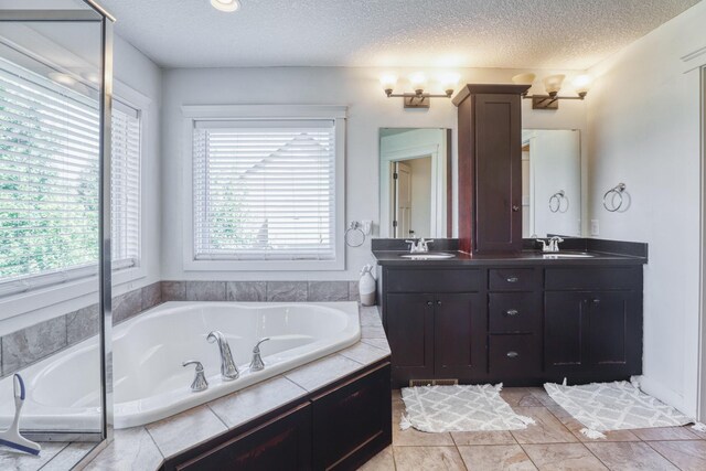 1730 Deephaven Dr, Woodbury, MN 55129 - full bath featuring a textured ceiling, a bath, and double vanity
