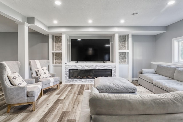 1730 Deephaven Dr, Woodbury, MN 55129 - living room with wood finished floors, recessed lighting, a fireplace, baseboards, and a textured ceiling