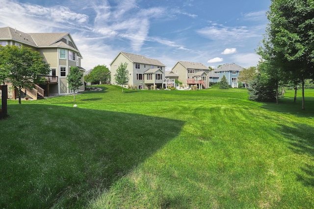 1730 Deephaven Dr, Woodbury, MN 55129 - view of grassy yard with a residential view, stairway, and a deck