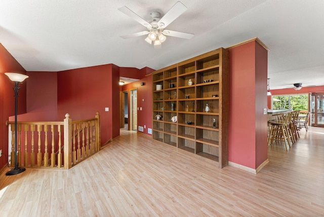 bonus room featuring a ceiling fan, wood finished floors, and baseboards