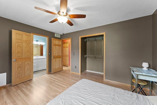 bedroom featuring a closet, light wood finished floors, baseboards, and ceiling fan