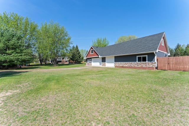 view of side of property featuring stone siding, a shingled roof, and a garage