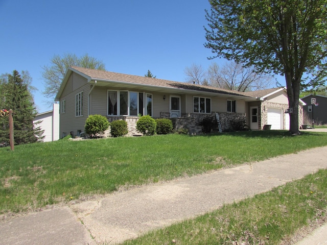 ranch-style home with an attached garage, a front lawn, and stone siding