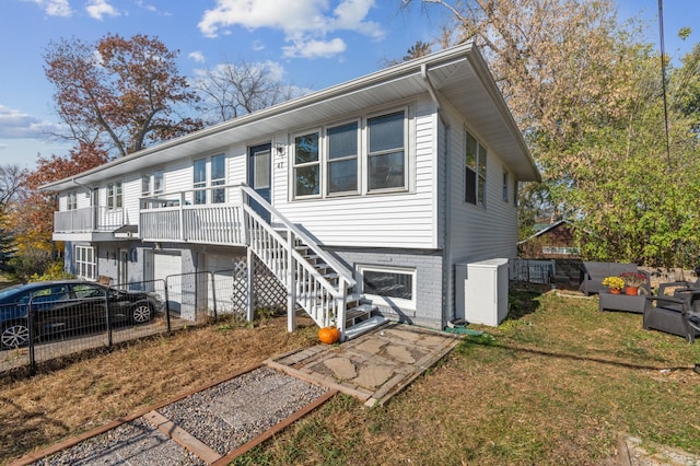 view of front of house featuring fence, central AC, and stairway