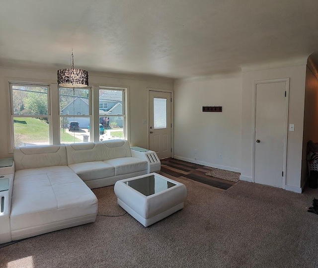 carpeted living room featuring plenty of natural light and baseboards