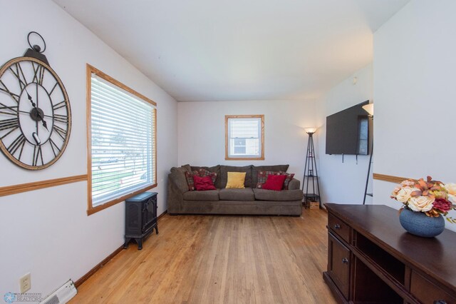 living room featuring light wood-type flooring and baseboards