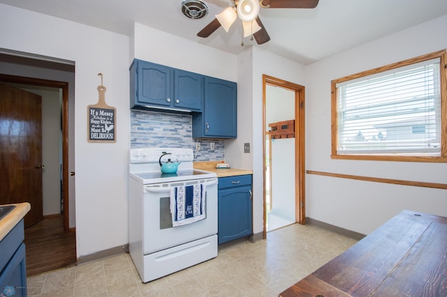 kitchen with white electric range, blue cabinetry, ceiling fan, decorative backsplash, and light countertops