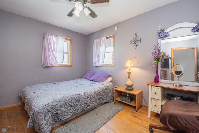 bedroom with light wood-style flooring and baseboards