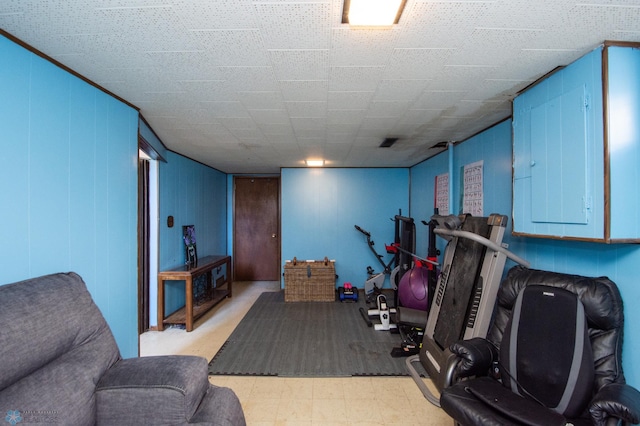 exercise area with electric panel and tile patterned floors