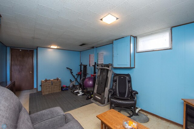 workout room featuring light floors and baseboards
