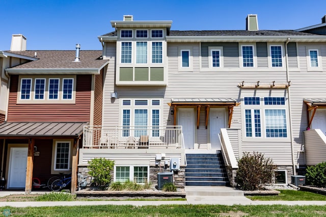 3313 5th Way E Unit B, West Fargo, ND 58078 - townhome / multi-family property with a chimney, a standing seam roof, and central air condition unit