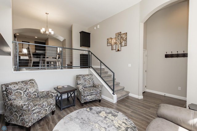 3313 5th Way E Unit B, West Fargo, ND 58078 - living area featuring arched walkways, wood finished floors, stairs, and baseboards