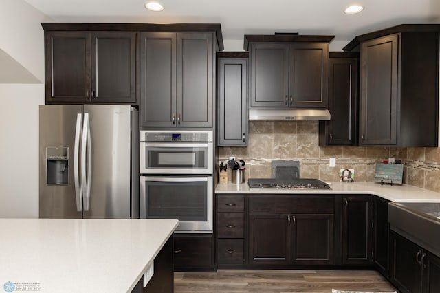 3313 5th Way E Unit B, West Fargo, ND 58078 - kitchen featuring stainless steel appliances, under cabinet range hood, recessed lighting, and light countertops