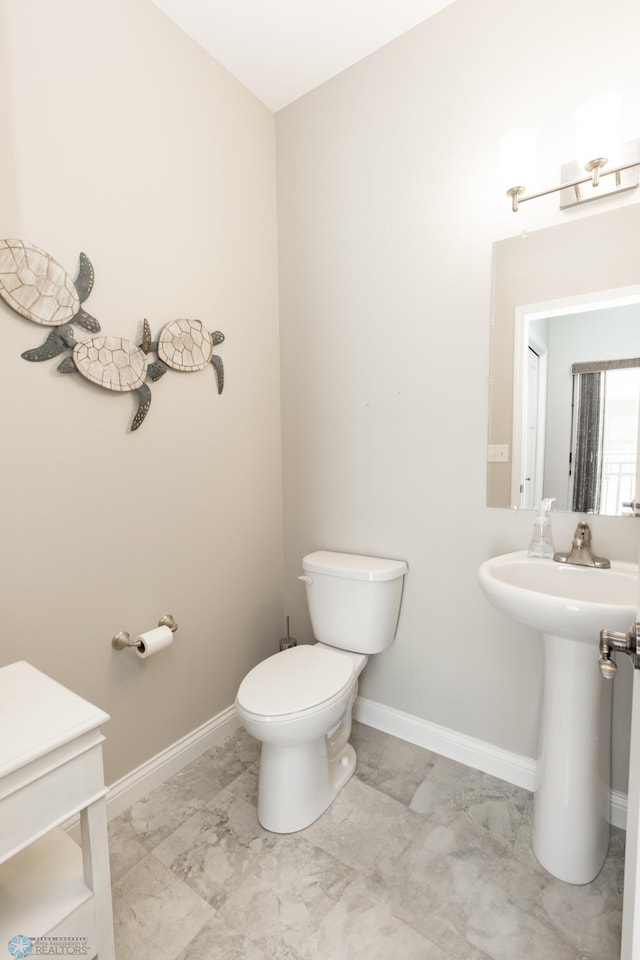 3313 5th Way E Unit B, West Fargo, ND 58078 - bathroom featuring marble finish flooring, toilet, and baseboards