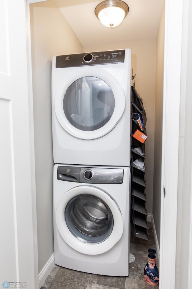 3313 5th Way E Unit B, West Fargo, ND 58078 - laundry room featuring stacked washing machine and dryer and baseboards