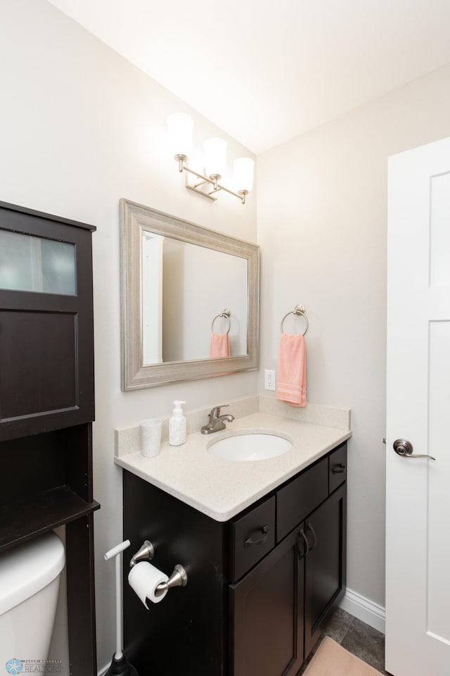 3313 5th Way E Unit B, West Fargo, ND 58078 - bathroom featuring vanity, toilet, tile patterned flooring, and baseboards