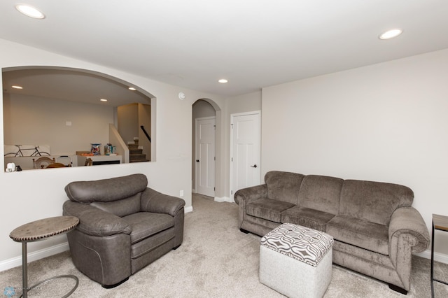 3313 5th Way E Unit B, West Fargo, ND 58078 - living room featuring arched walkways, carpet floors, recessed lighting, stairway, and baseboards