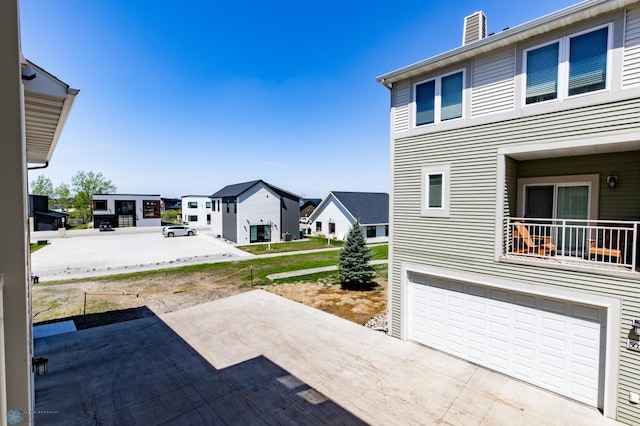 3313 5th Way E Unit B, West Fargo, ND 58078 - view of patio with a garage and a residential view