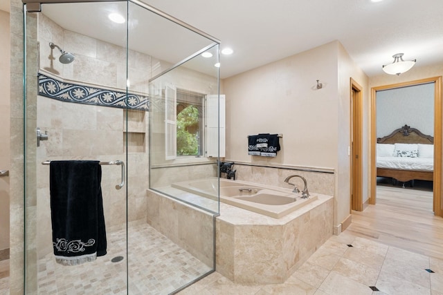 10420 Bluff Cir, Chaska, MN 55318 - full bath with connected bathroom, a bath, a shower stall, recessed lighting, and tile patterned flooring