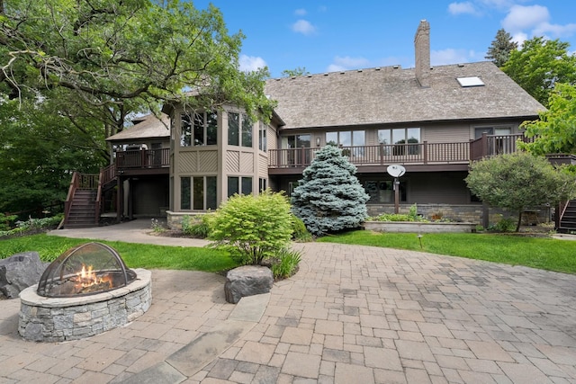10420 Bluff Cir, Chaska, MN 55318 - rear view of property with a fire pit, stairway, a deck, and stone siding