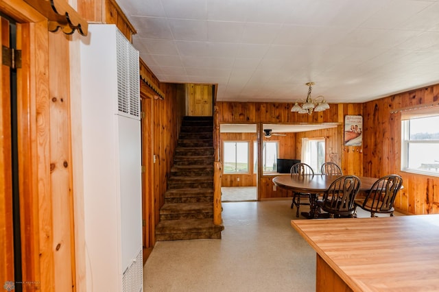 20841AND20850 Leona Beach Rd, Erie Twp, MN 56578 - dining area with a heating unit, wood walls, stairway, and a chandelier