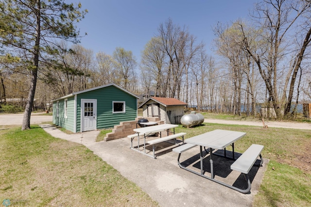 20841AND20850 Leona Beach Rd, Erie Twp, MN 56578 - rear view of house featuring an outdoor structure and a lawn
