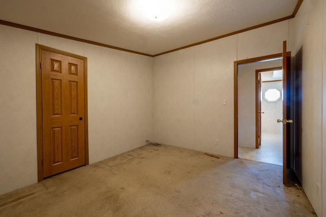 36308 Edgewood Rd, Harmony, MN 55939 - empty room with crown molding, carpet, a textured ceiling, and a decorative wall