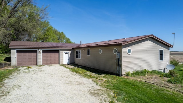 36308 Edgewood Rd, Harmony, MN 55939 - view of front of home featuring a garage, metal roof, and driveway
