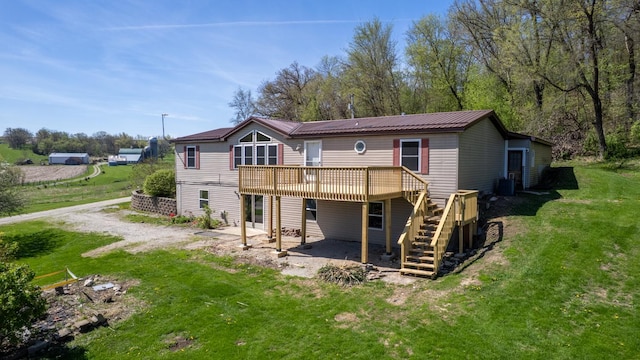 36308 Edgewood Rd, Harmony, MN 55939 - back of property featuring a deck, stairway, a lawn, a patio, and central AC unit