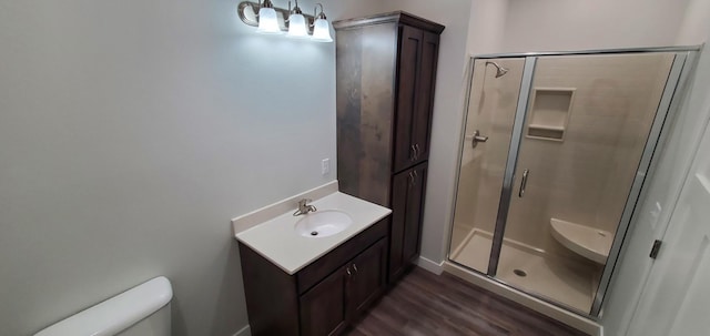 715 Lake Shore Dr NE Unit 207, Bemidji, MN 56601 - full bathroom featuring toilet, a shower stall, wood finished floors, and vanity