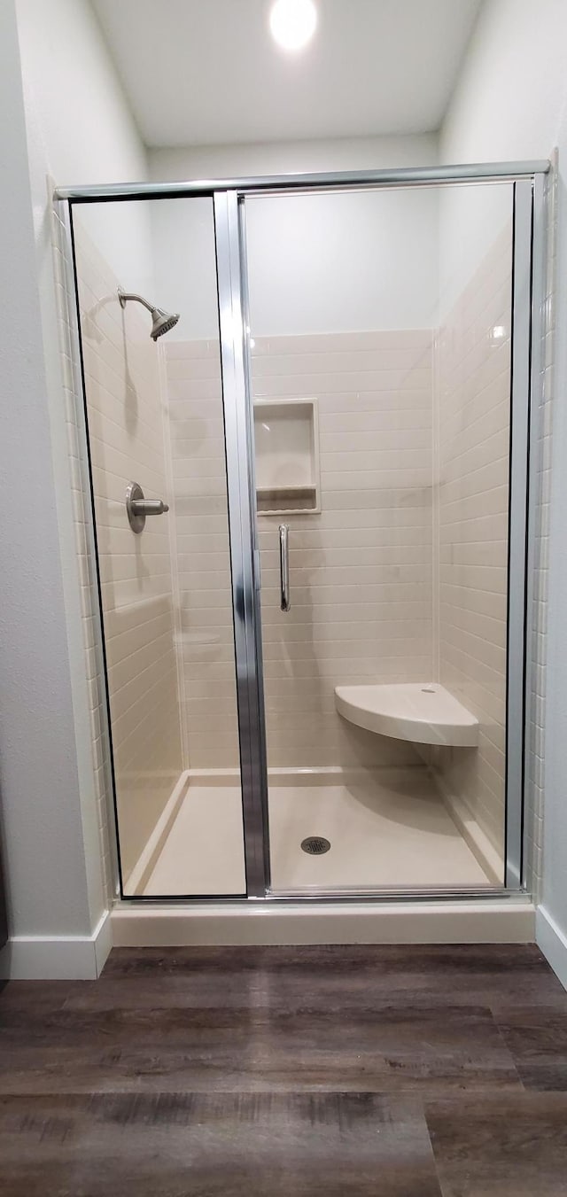 715 Lake Shore Dr NE Unit 207, Bemidji, MN 56601 - full bath with a stall shower, baseboards, and wood finished floors