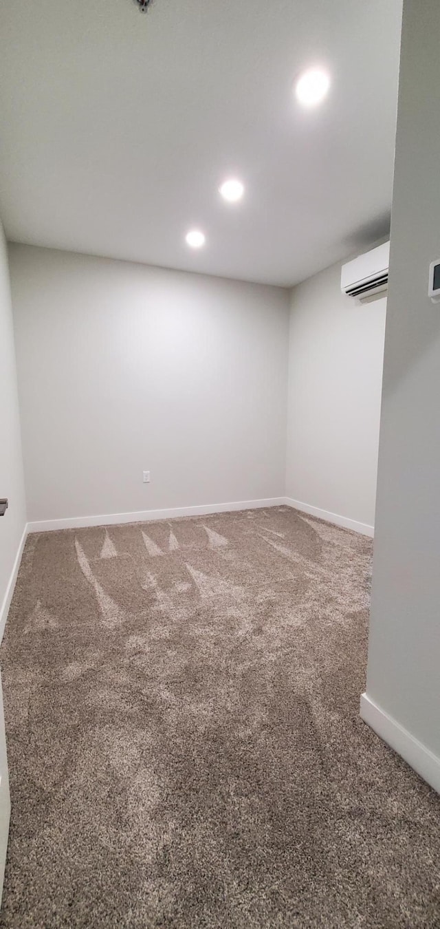 715 Lake Shore Dr NE Unit 207, Bemidji, MN 56601 - basement with carpet floors, a wall mounted AC, baseboards, and recessed lighting