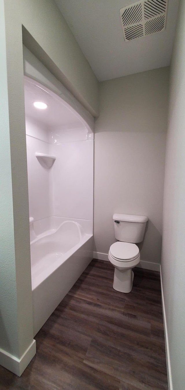 715 Lake Shore Dr NE Unit 207, Bemidji, MN 56601 - full bath featuring baseboards, toilet, wood finished floors, and washtub / shower combination