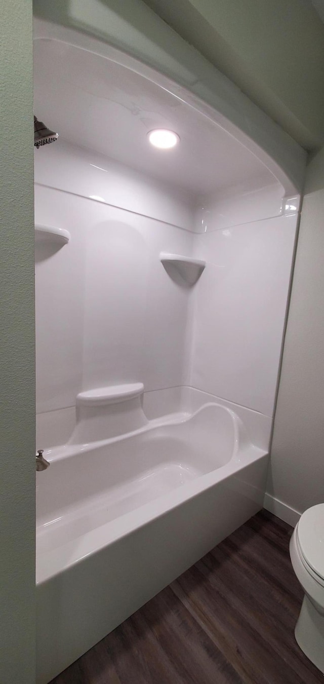 715 Lake Shore Dr NE Unit 207, Bemidji, MN 56601 - bathroom with wood finished floors, toilet, and shower / tub combination