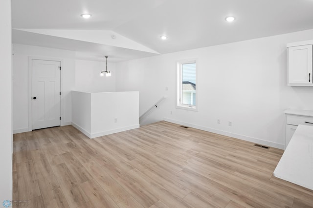 7279 26th St S, Fargo, ND 58104 - unfurnished dining area with vaulted ceiling, light wood-style floors, baseboards, and recessed lighting